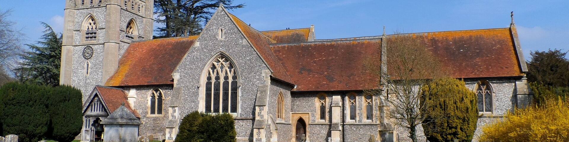 A historic church with a tall tower and a large arched window.