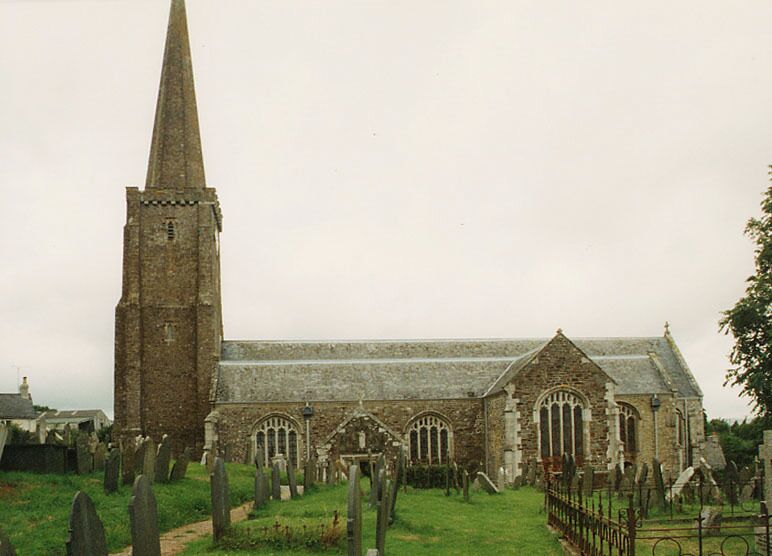 A church with a tall spire and arched windows, surrounded by a cemetery.
