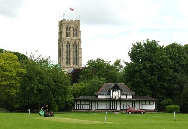 Preparing the wicket, Howden, East Riding of Yorkshire, England. The cricket ground and pavilion at Ashes Field Howden.