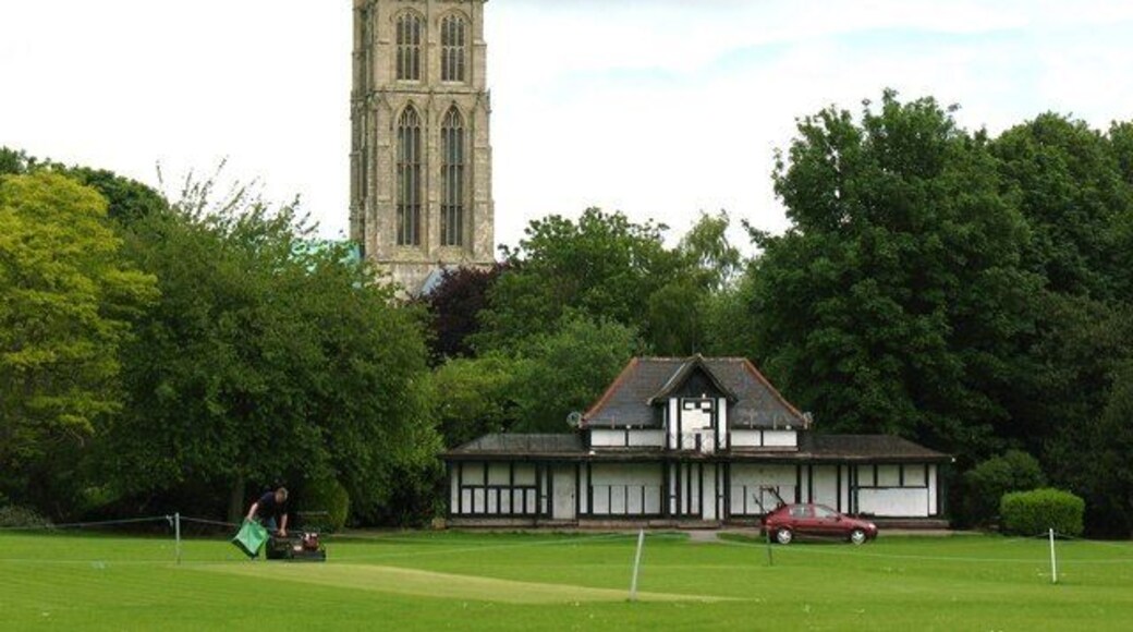 Preparing the wicket, Howden, East Riding of Yorkshire, England. The cricket ground and pavilion at Ashes Field Howden.