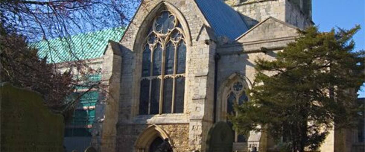Howden Minster tower, Howden, East Riding of Yorkshire, England Seen from the churchyard to the south. Scaffolding can be seen to the left of the picture for the restoration work on the south side of the church.