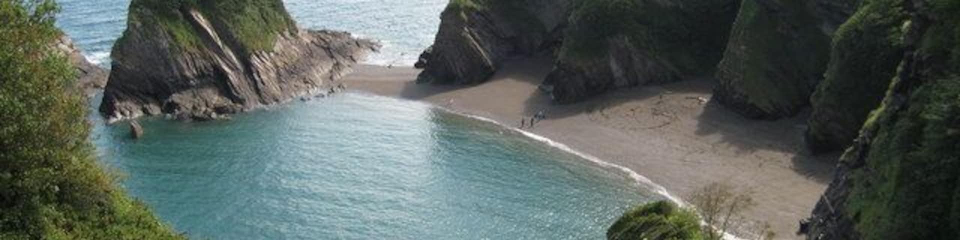 Broadsands viewed from the coast path The sandy beach of Broadsands viewed from the South West Coast Path, Little Hangman and Hangman Point, beyond Combe Martin, can be seen in the background.