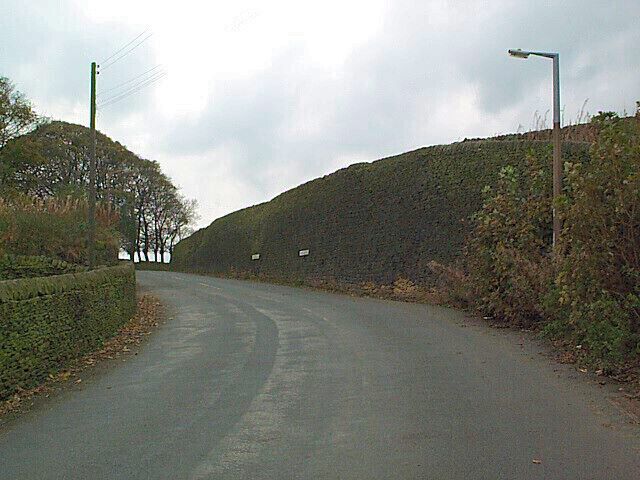 Dry stone retaining wall near Lane End. This sizeable construction is situated outside Lane End on the road to Colne, where Denby Hill Road becomes Hob Cote Lane (the signage can be see at the centre of the photograph).