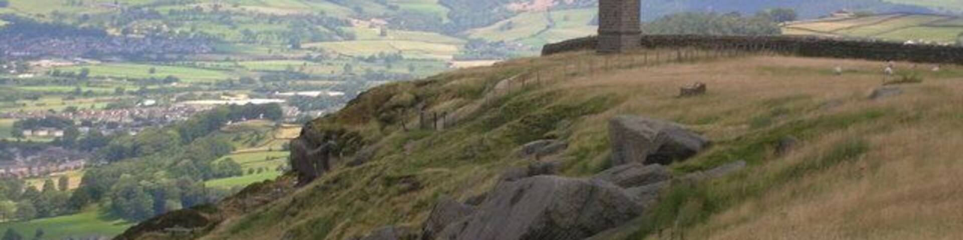 A tower on a hill overlooking a valley.