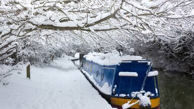 Deep snow lines a canal near Oxford