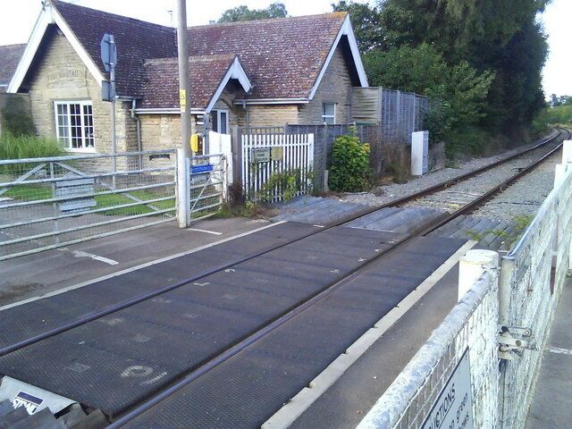 User-worked railway level crossing in Mill Street, Islip, Oxfordshire. This view is in the direction of Islip railway station. The cottage was originally for the crossing keeper.
