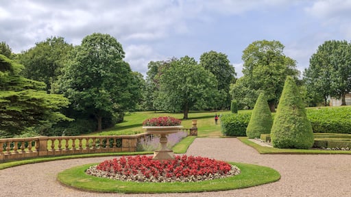 Formal gardens in Tatton Park with stone balustrade, Edwardian tazza planter in the centre of a circular flower bed.