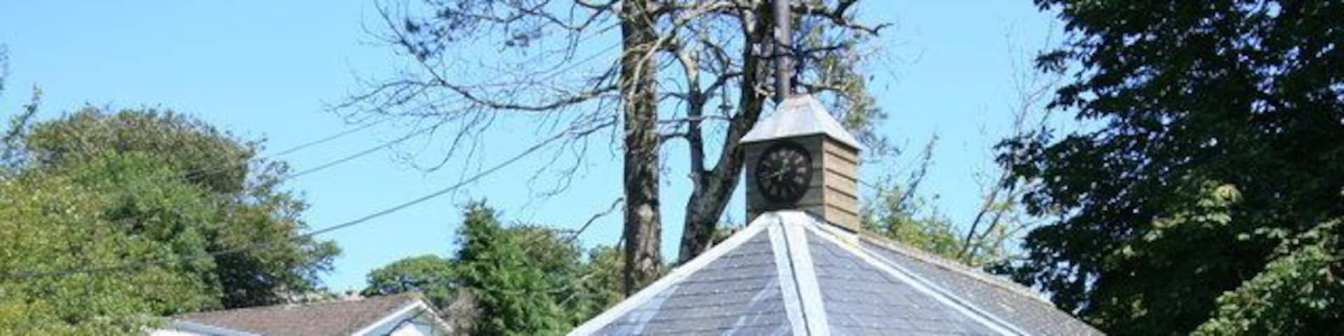 Millennium Shelter in Lanreath This shelter, with its clock and village noticeboard, was built to commemorate the Millennium in 2000. It forms a pleasant green central to the village, with the Post Office and Village Shop behind alongside the church carpark.