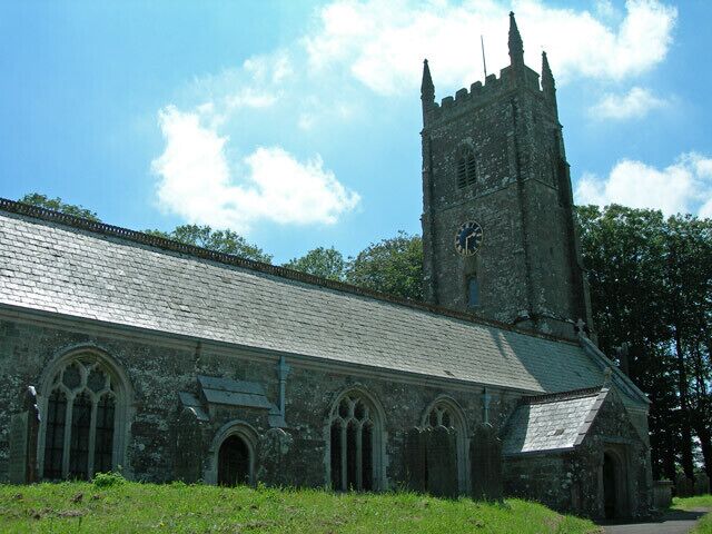 A historic church with a tall tower and arched windows.