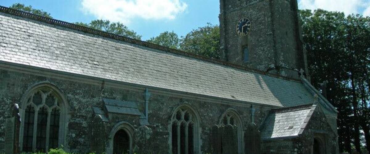 A historic church with a tall tower and arched windows.