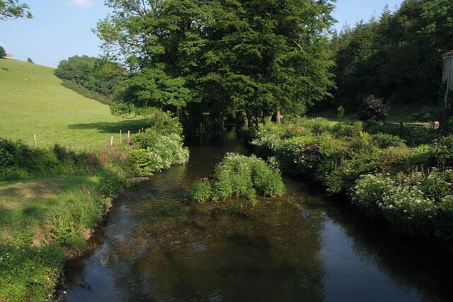 The River Lynher at Bicton Mill The Lynher is a small river flowing off Bodmin Moor and through beautiful wooded valleys. It eventually flows into the Tamar estuary at SX4257. The rising ground on the left and the river up to the large tree are in the featured square. The woodland on the right, Bicton Wood, and the line of trees at the edge of the field on the hill are in SX3269.