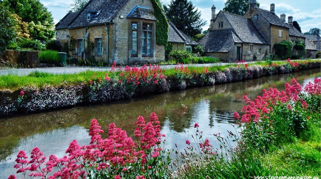 Lower Slaughter is currently my pick for most picturesque village in England that I have seen so far. It is a very small village in the county of Gloucestershire located in the Cotswold District. Through the middle of the village flows the River Eye and from the flower covered banks you can watch the trout swimming in the crystal clear water.
At one end of the village next to the river is The Old Mill which is has a working (not all the time) undershot waterwheel. There is a small museum, craft shop and tearooms which are worth a visit. It is not as busy or touristy as the nearby popular Bourton-on-the-Water this is because there is no parking for the large tour buses which I think help keep the village's charm.