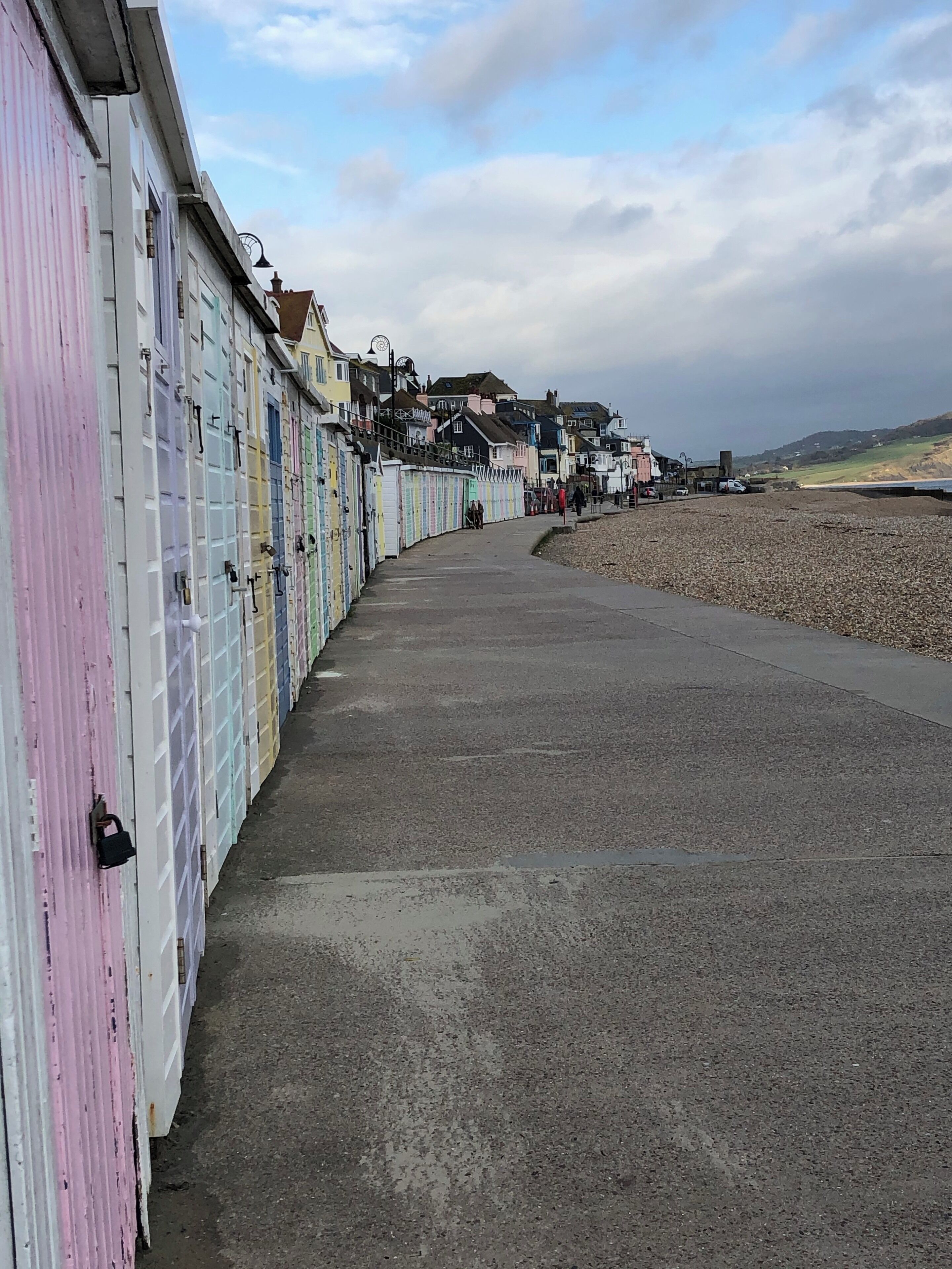 The pretty ice cream colours of the beach huts along Lyme Regis Beach.