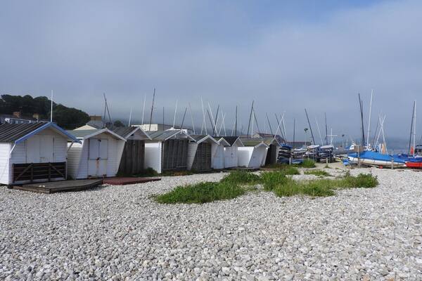 Bordering Monmouth Beach in Lyme Regis, England, are holiday chalets, beach huts, the bowling green, Lyme Regis Power Boat Club and Boat Building Academy. Here you can find a layer of limestone called the ammonite graveyard or the ammonite pavement. This layer of rock is famous for the large ammonites it contains.