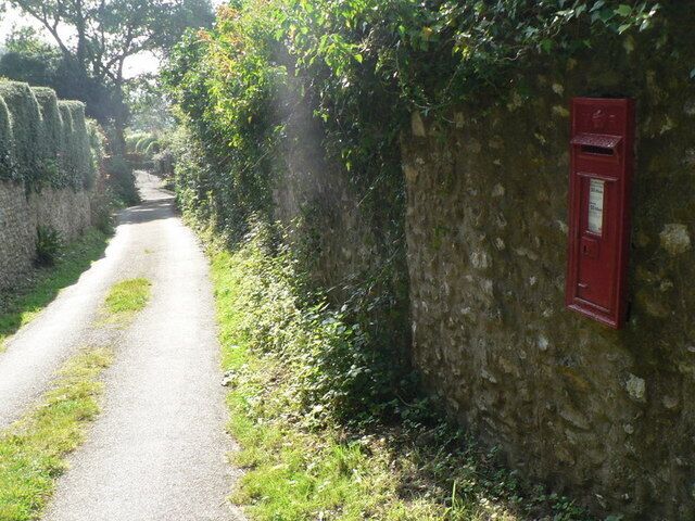 Rocombe: postbox № DT7 39 A Victorian postbox set into the western wall of the lane through the village.