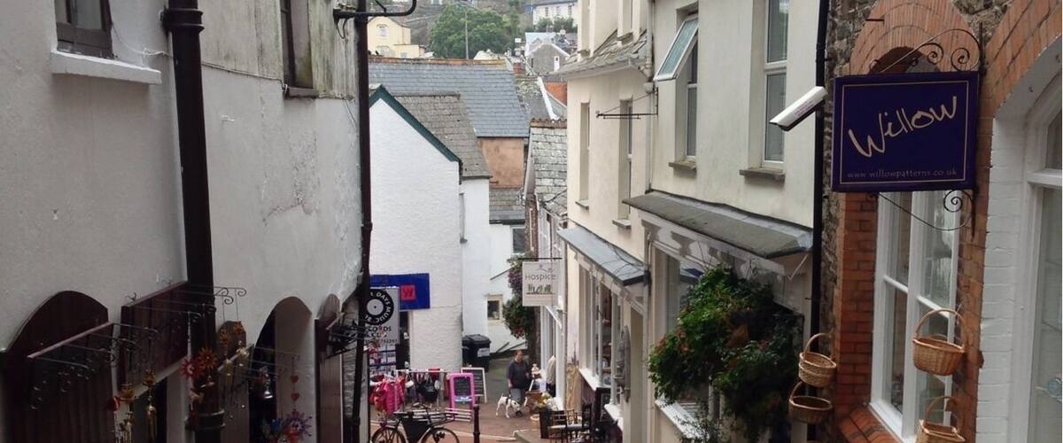 A narrow street lined with shops and baskets.