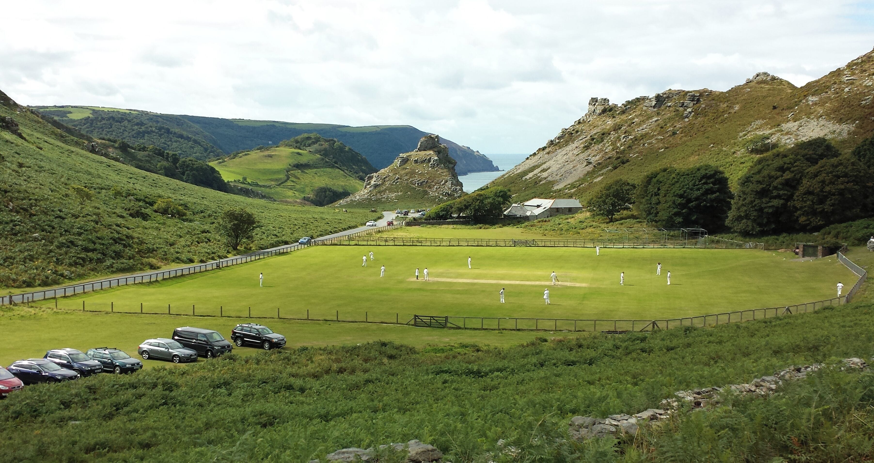 A cricket match in progress on the Lynton and Lynmouth cricket ground in the Valley of the Rocks