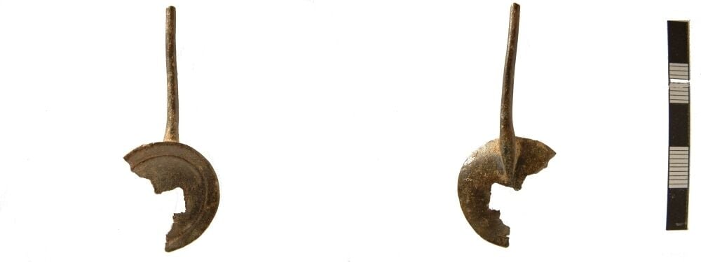 Incomplete Roman copper alloy spoon, missing part of its handle and bowl. It is 56mm in length and the bowl 26mm in diameter (though due to damage only 24mm in max width). The damage on the bowl is quite jagged and sharp unlike the break on the handle, which is probably more ancient. The bowl has a rib running parallel to the outside edge c.3mm from it. On the reverse the handle tapers to a point on the bowl. The reverse has a small area of tinning beside the handle. Weighs 4.12g. Cf a very similar example from South Shields Roman Fort, in Allason-Jones and Miket, 1984, no.3.321.