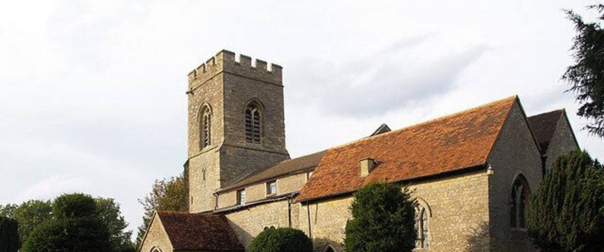 A church with a tower and arched windows.