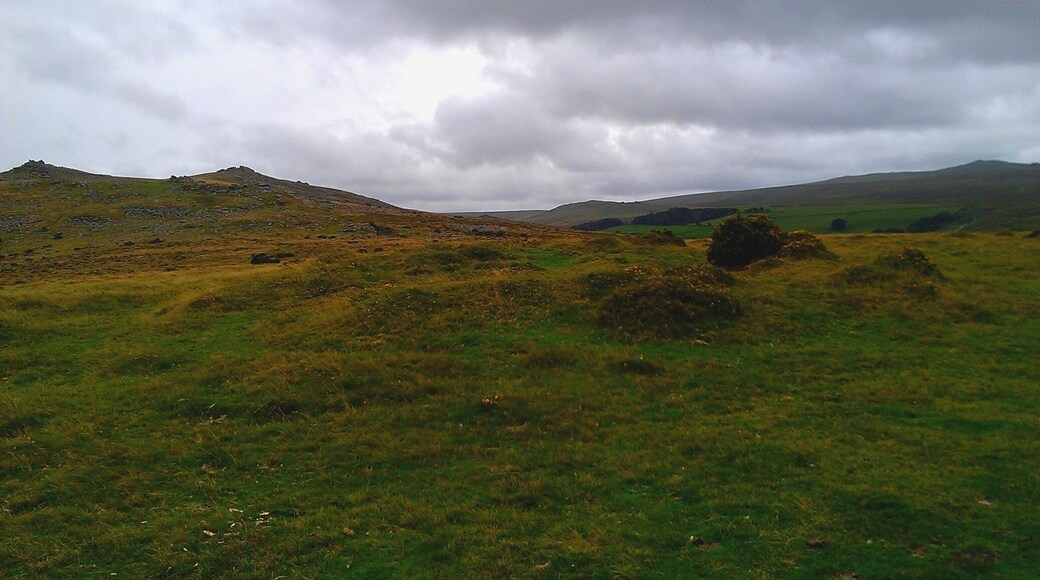 The Bronze Age round barrow atop Watchet Hill near to the village of Belstone in Dartmoor, Devon. This photograph was taken facing a south-easterly direction, with Belstone Tor in the background (left).