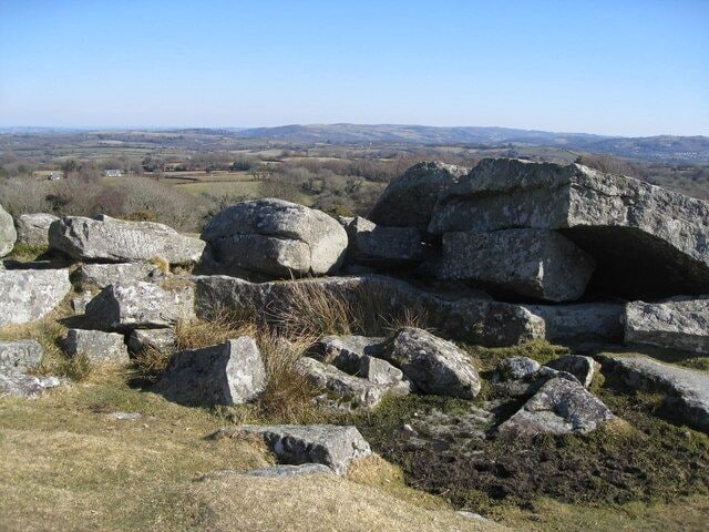 Shilstone Tor This tor looks out east and from here Castle Drogo can be spotted on the horizon and is just left of centre in the photo scarcely visible in this photo, but it does indicate the extent of the view if related to the OS map. The Shilstone Tor has clearly been used by stone masons in days gone by as there are signs of their drilling and cleaving scattered around. Around 1905 a house called 'Midway' was built by local landowner Willoughby Lowe and is fine example of a more modern granite built house. The house is on the road leading down from Shilstone Tor into the village of Throwleigh (pronounced: Throwl-eigh)and is appropriately named as it is mid-way along this road to the village from Shilstone Tor. 'Midway' was once lived in briefly by Devon born artist Sydney Curnow Vosper 1909/10. The house has since been extensively extended.