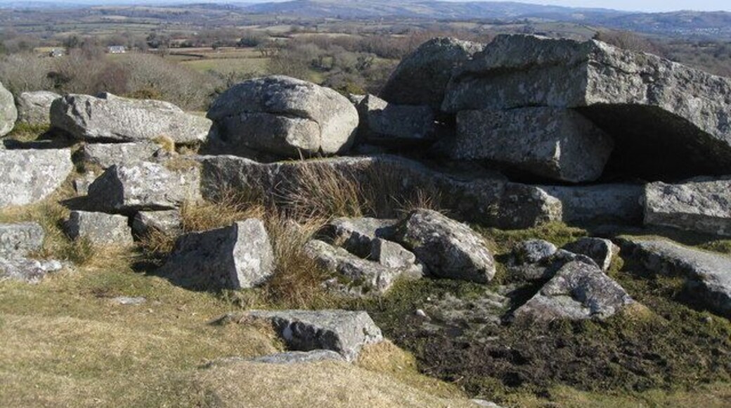 Shilstone Tor This tor looks out east and from here Castle Drogo can be spotted on the horizon and is just left of centre in the photo scarcely visible in this photo, but it does indicate the extent of the view if related to the OS map. The Shilstone Tor has clearly been used by stone masons in days gone by as there are signs of their drilling and cleaving scattered around. Around 1905 a house called 'Midway' was built by local landowner Willoughby Lowe and is fine example of a more modern granite built house. The house is on the road leading down from Shilstone Tor into the village of Throwleigh (pronounced: Throwl-eigh)and is appropriately named as it is mid-way along this road to the village from Shilstone Tor. 'Midway' was once lived in briefly by Devon born artist Sydney Curnow Vosper 1909/10. The house has since been extensively extended.