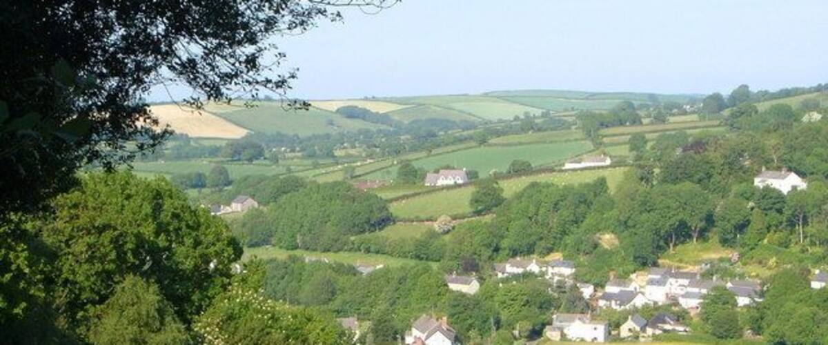 View near South Zeal. From a junction in the network of tracks leading through fields and up to the moor above South Zeal. On the left below is the Hillfield estate.