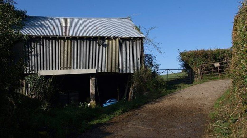 Barn at Mill Farm A corrugated iron barn by the farm road carrying Drewsteignton Footpath 8 up from the Fingle Brook valley towards the A382.