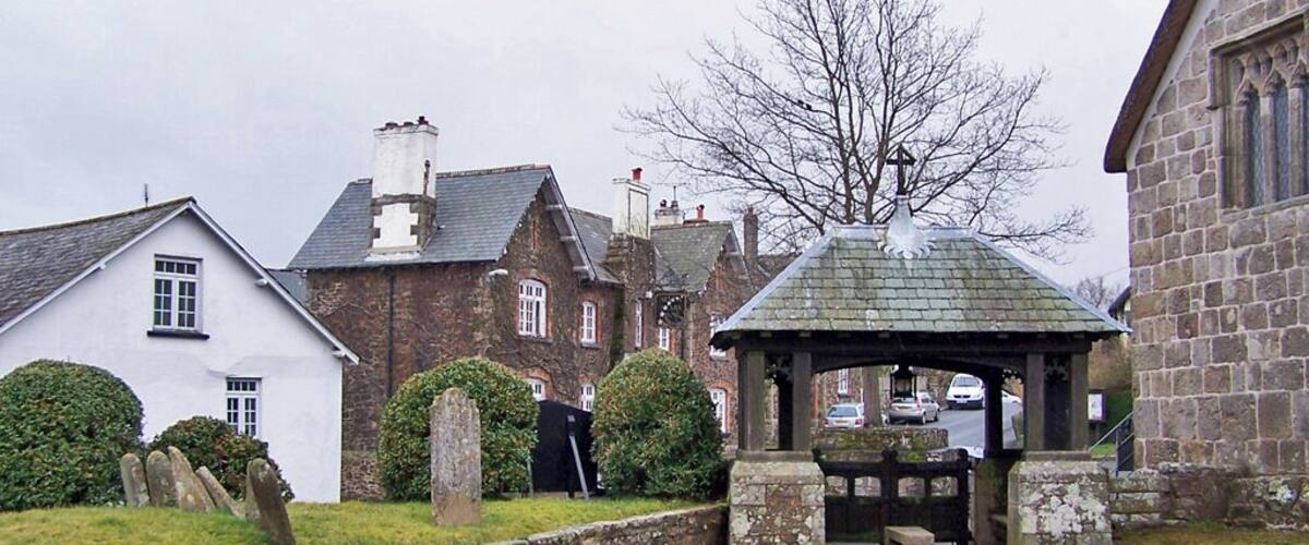 Lych gate of St. Andrew's church, South Tawton. Seen from inside the churchyard. Church House is to the right, 1772728, and the Seven Stars public house is the stone building to the left of the lych gate 1772736.