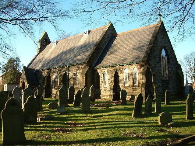 A church with a steeply pitched roof and multiple pointed arches.