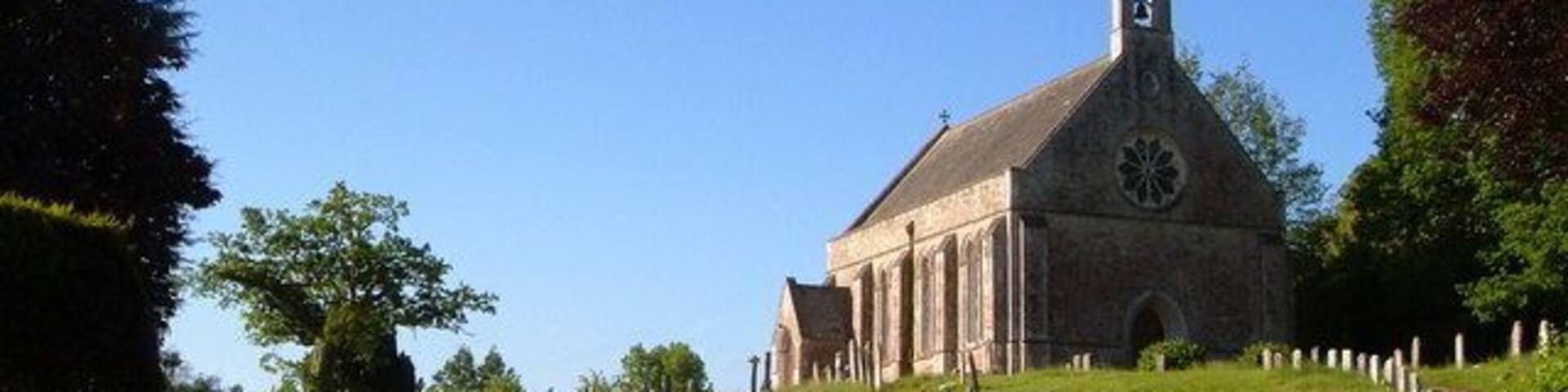 St John's church, Tipton St John. In the western part of the village, Tipton Vale, on the west side of the River Otter. The church, on its hill overlooking a narrow stretch of lane, dates from 1839-40.