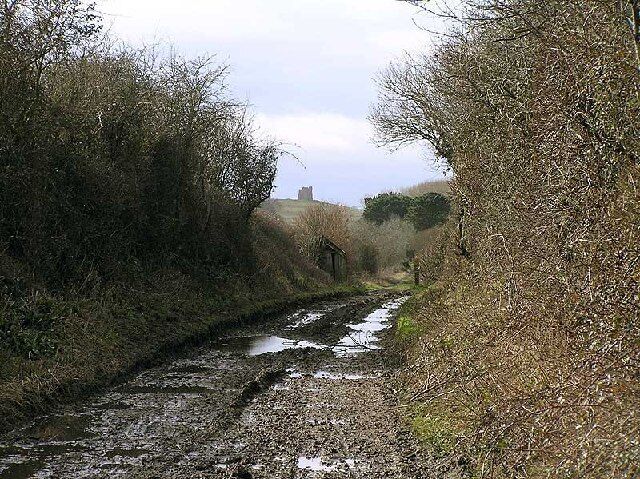 Disused railway near Portesham. Trackbed of line between Upwey and Abbotsbury, closed 1952, with gangers hut and St Catherine's Chapel in distance.