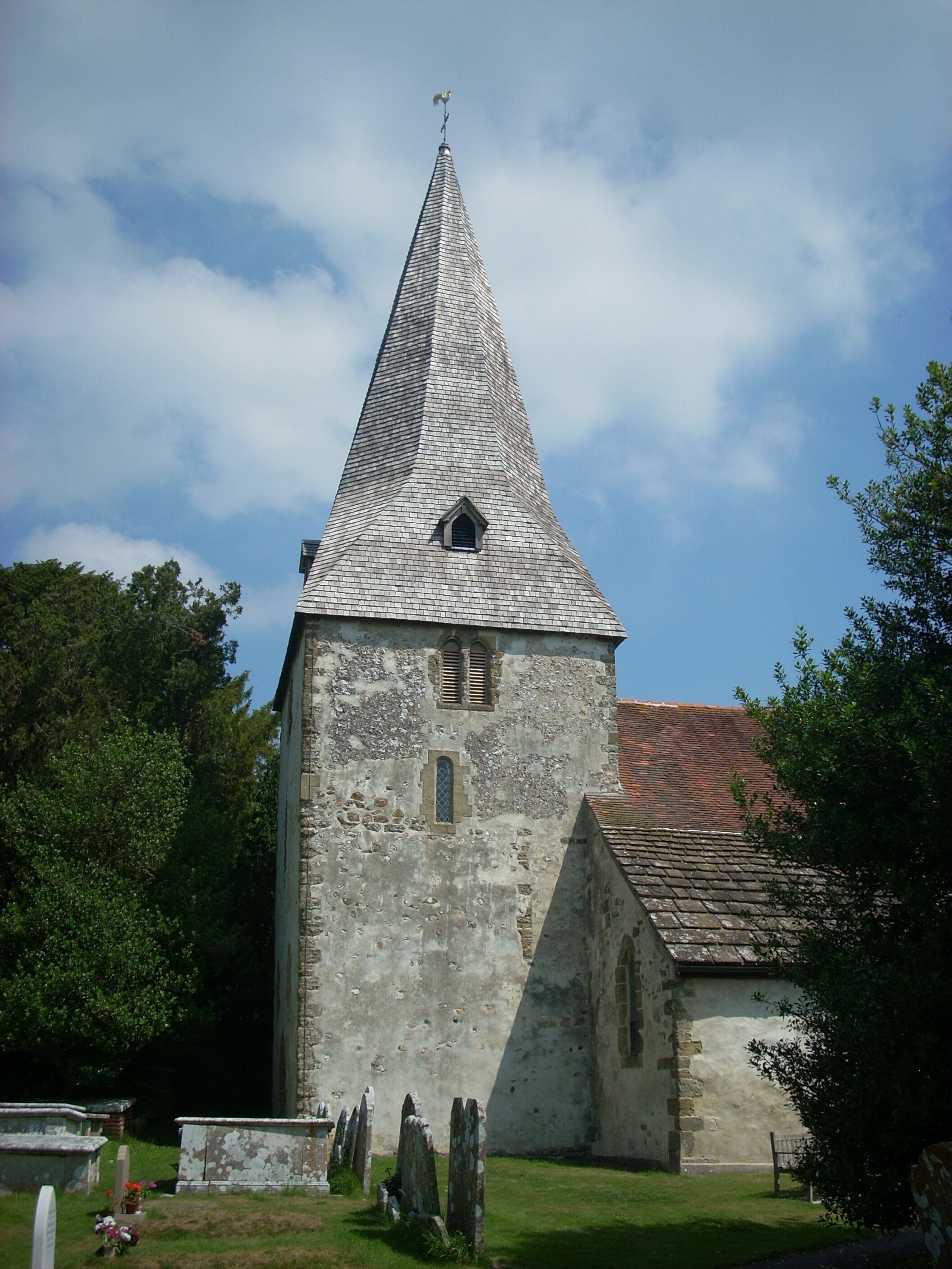 The 12th century tower of the church of St John the Evangelist in Bury, West Sussex, UK.