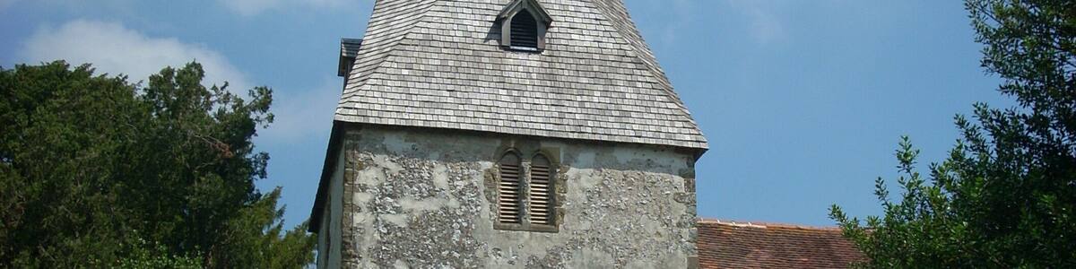 The 12th century tower of the church of St John the Evangelist in Bury, West Sussex, UK.