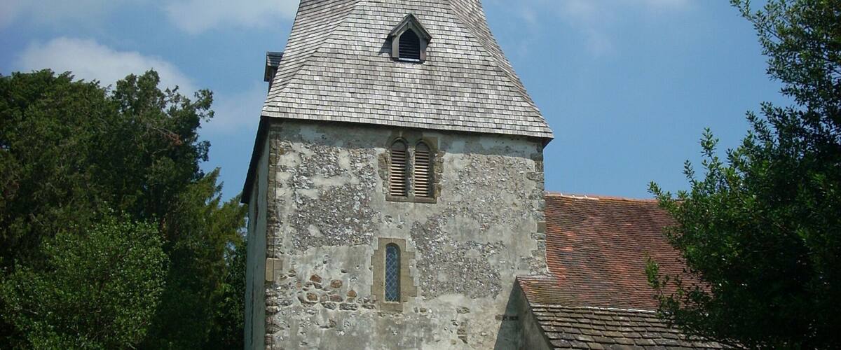 The 12th century tower of the church of St John the Evangelist in Bury, West Sussex, UK.