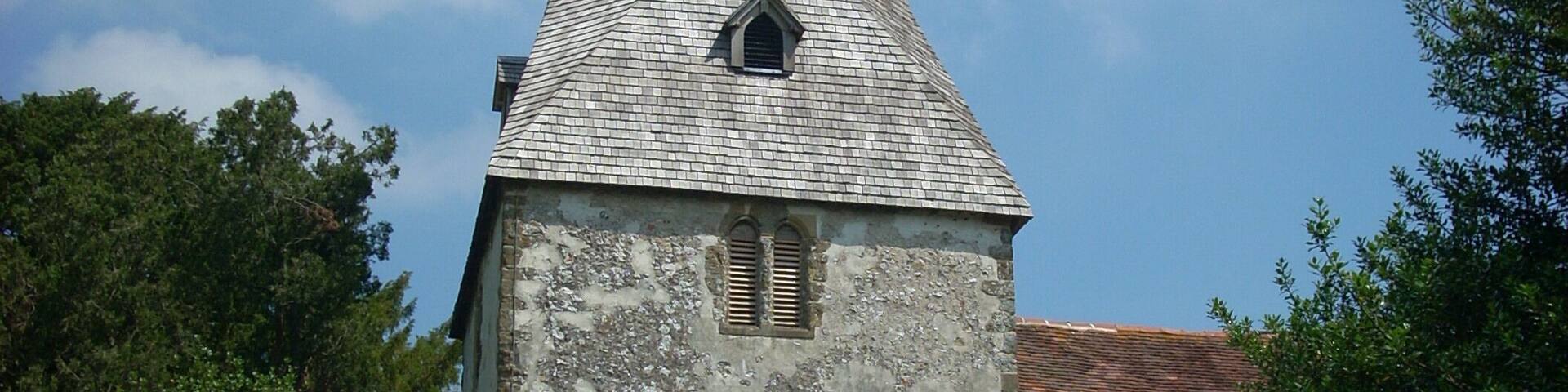 The 12th century tower of the church of St John the Evangelist in Bury, West Sussex, UK.