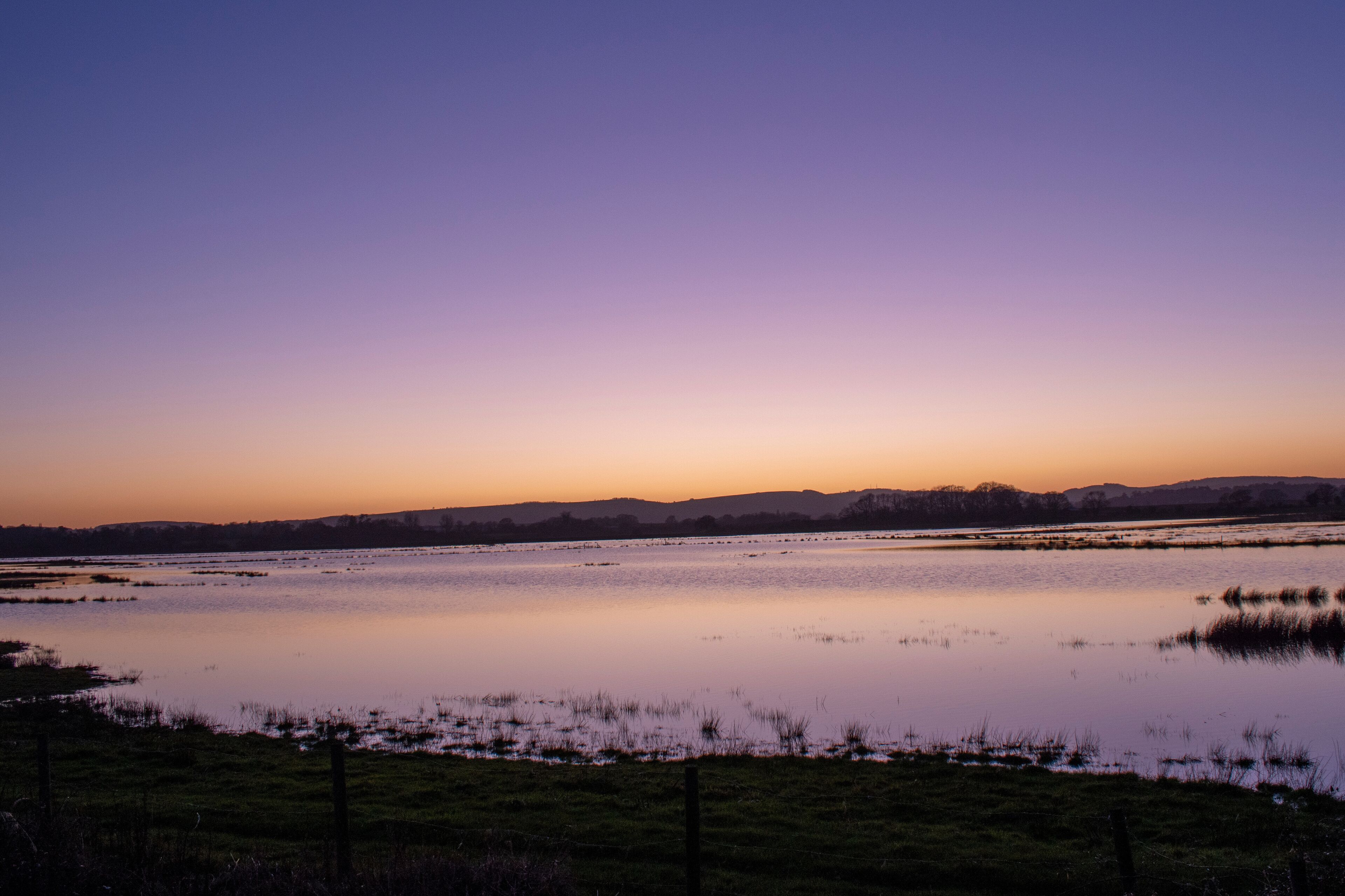 Sunset over a lake at Pulborough Brooks nature reserve.