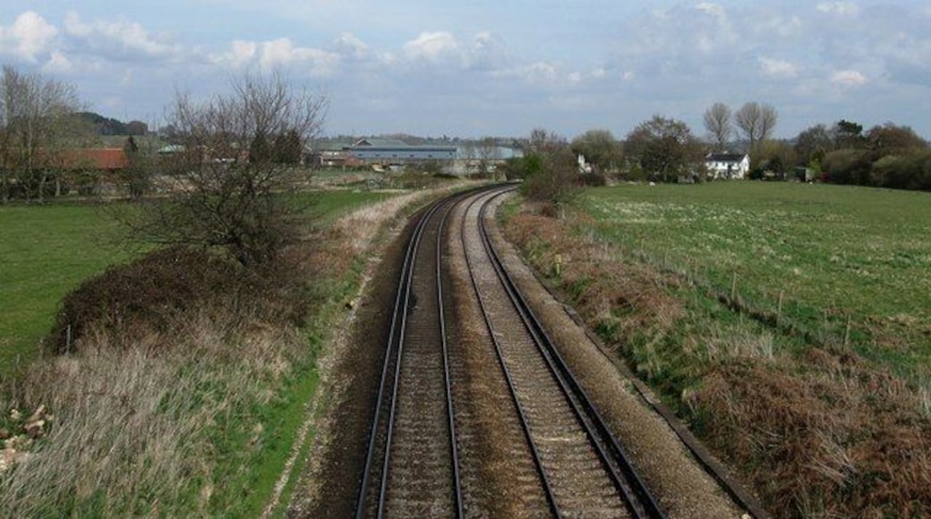 Arun Valley Line Viewed from the footbridge that was originally built to allow canal horses a route over the railway as the barges were 'legged' through Hardham Tunnel below. The curve in the line was also the site of a former railway junction which existed between 1863-1966 when the Midhurst branch was dismantled. The buildings centre left are part of the Hardham Water Supply Works.