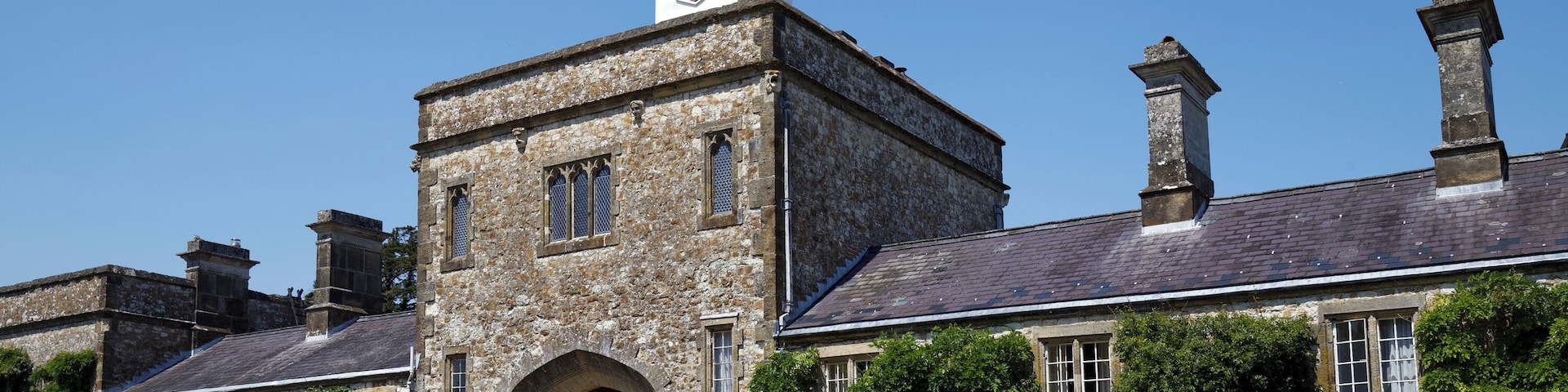 The Grade I listed three-floored 18th-century carriage arch block leading to the stables and laundry wing, and defining the north of the courtyard of Parham House, in West Sussex, England. Camera: Canon EOS 6D with Canon EF 24-105mm F4L IS USM lens. Software: file lens-corrected and optimized with DxO OpticsPro 10 Elite and Viewpoint 2, and further optimized with Adobe Photoshop CS2.
