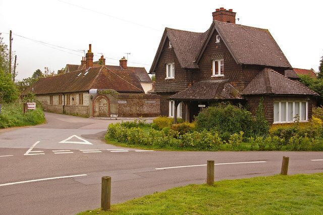 West Lodge, Pendell Court. One of two former lodges of Pendell Court (see 1564414). Behind are the barns of Pendell Farm.