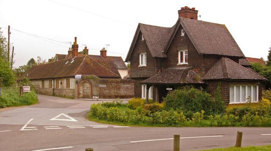 West Lodge, Pendell Court. One of two former lodges of Pendell Court (see 1564414). Behind are the barns of Pendell Farm.
