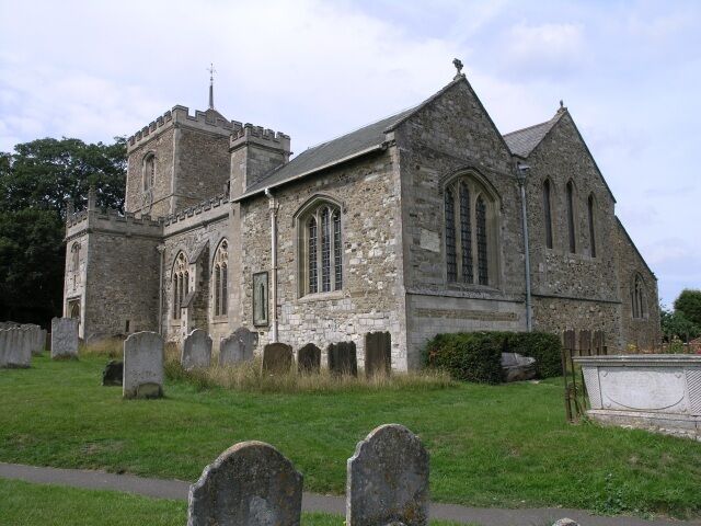 St Mary the Virgin, Bletchingley. The tower dates back to circa 1090, with the porch and oak door dating to 1460. The tower originally had a spire, but this was destroyed when it was struck by lightning in 1606. The nave is comparatively modern, being built in 1856. Just beneath the window covered with glass is a smaller round hole (partially covered by a gravestone in this picture). This was possibly used by Roger the Hermit, who is said to have visited these parts in the 13th-century.