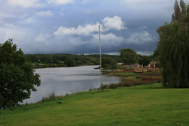 The old mill pond at Wootton A view looking across the mill pond with a glimpse of the new leisure complex on the right. I should probably have chopped down the flag pole before I took this picture.