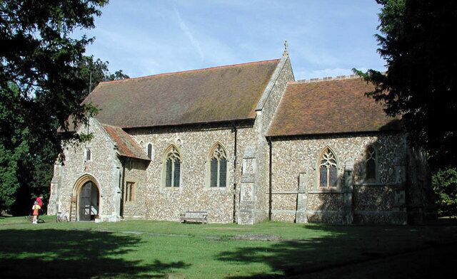 A stone church with a steeply pitched roof and arched windows.