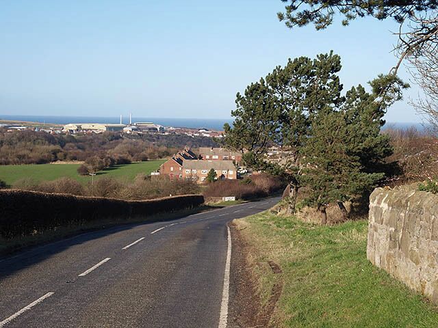 Approaching Liverton Mines Heading north on the B1366. Steelworks at Carlin How can be seen in the distance.