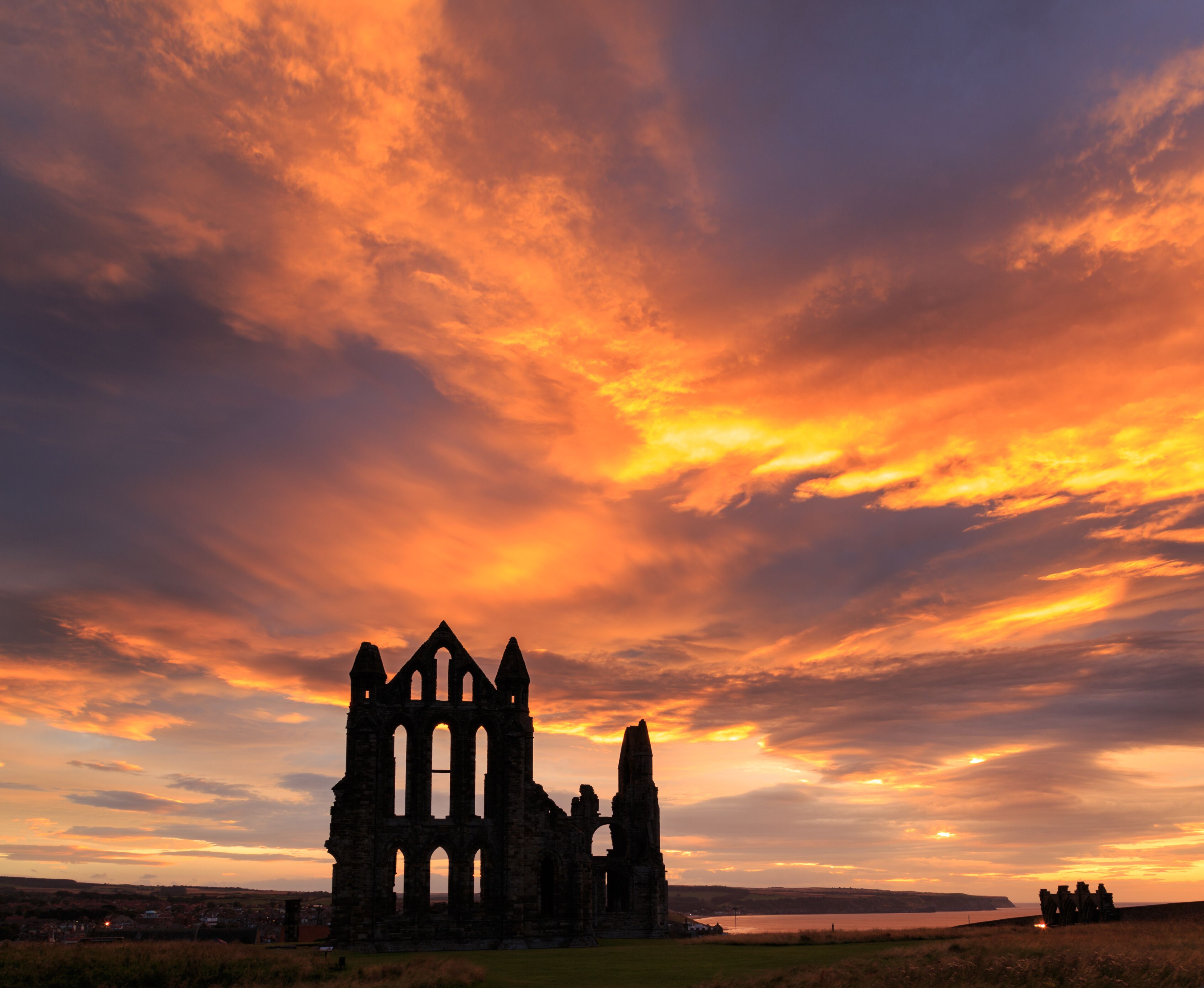 WHITBY, ENGLAND - AUGUST 12: Whitby Abbey against a dramatic sunset. In Whitby, North Yorkshire, England. On 12th August 2016