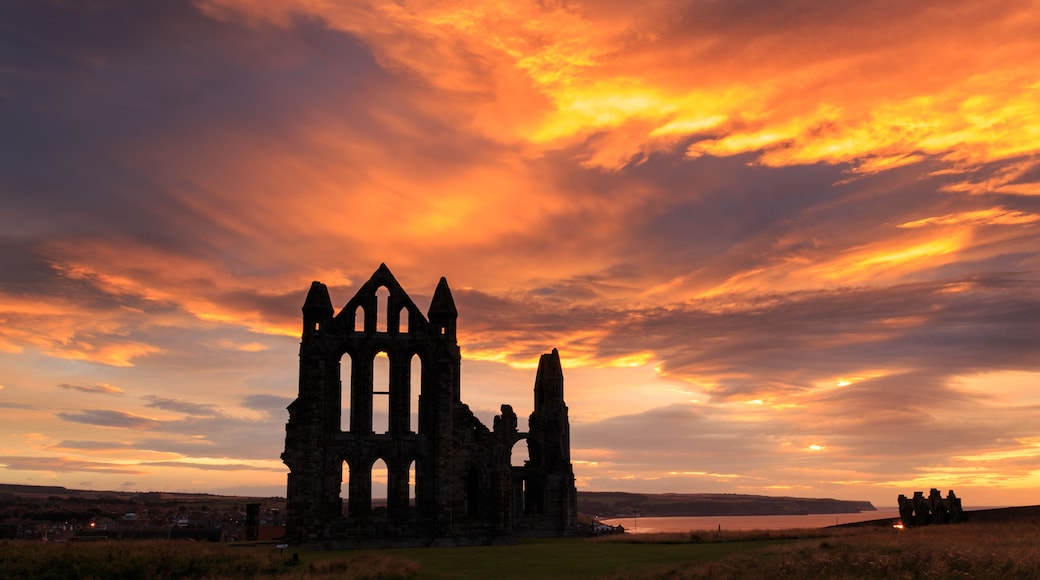 WHITBY, ENGLAND - AUGUST 12: Whitby Abbey against a dramatic sunset. In Whitby, North Yorkshire, England. On 12th August 2016