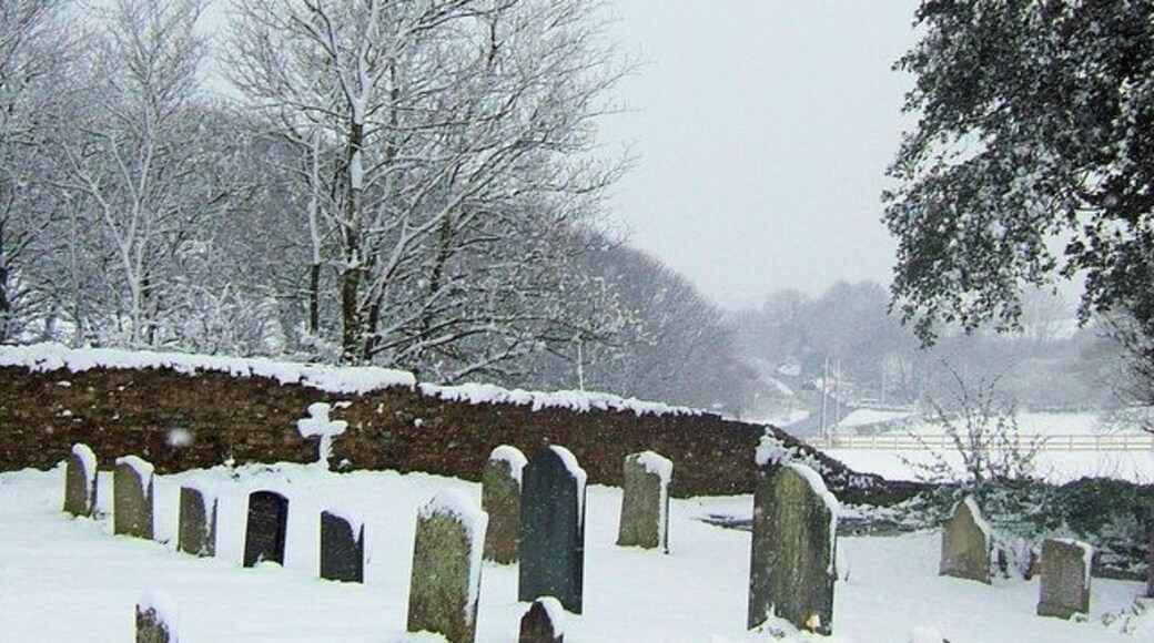 Bishopstone Road from St Andrew's Churchyard, Bishopstone, East Sussex A car can just be seen approaching Bishopstone along the wet road.