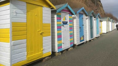 Stunning little sheltered beach with colourful huts ☀️