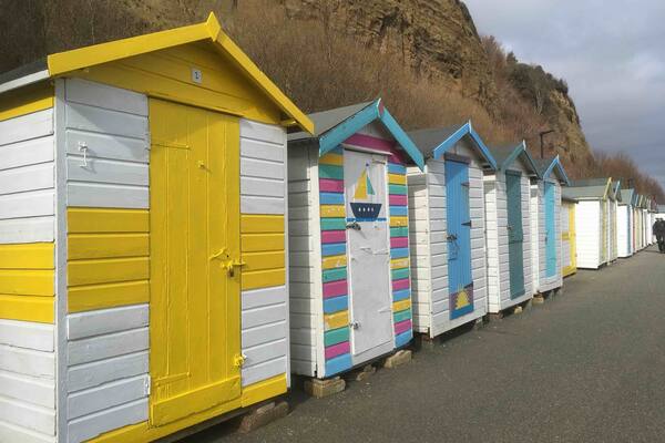 Stunning little sheltered beach with colourful huts ☀️